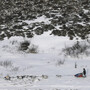 Researchers say that springtime snow is melting in the Arctic even faster than Arctic ice. That means less sunlight is reflected off the surface. Bare land absorbs more solar energy, which can contribute to rising temperatures on Earth. Above, a musher races along the Iditarod in the Alaskan tundra in 2007. Researchers say that springtime snow is melting in the Arctic even faster than Arctic ice. That means less sunlight is reflected off the surface. Bare land absorbs more solar energy, which can contribute to rising temperatures on Earth. Above, a musher races along the Iditarod in the Alaskan tundra in 2007.