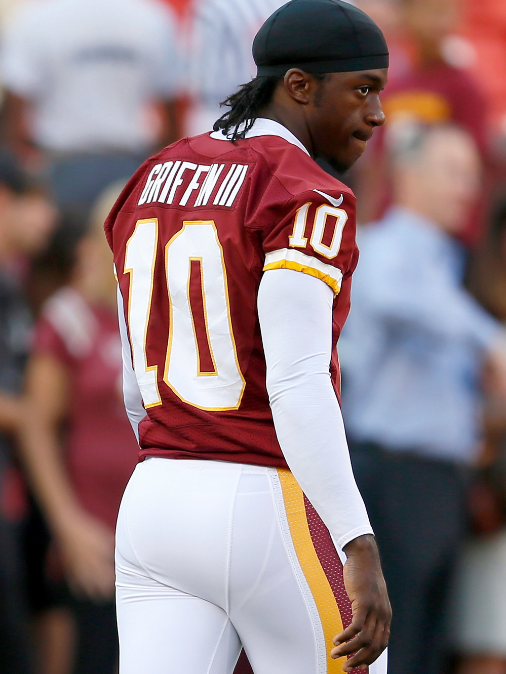 Washington Redskins quarterback Robert Griffin III watches from the sidelines. RG3 as he is known has a fan in other thirds like Frank Deford.