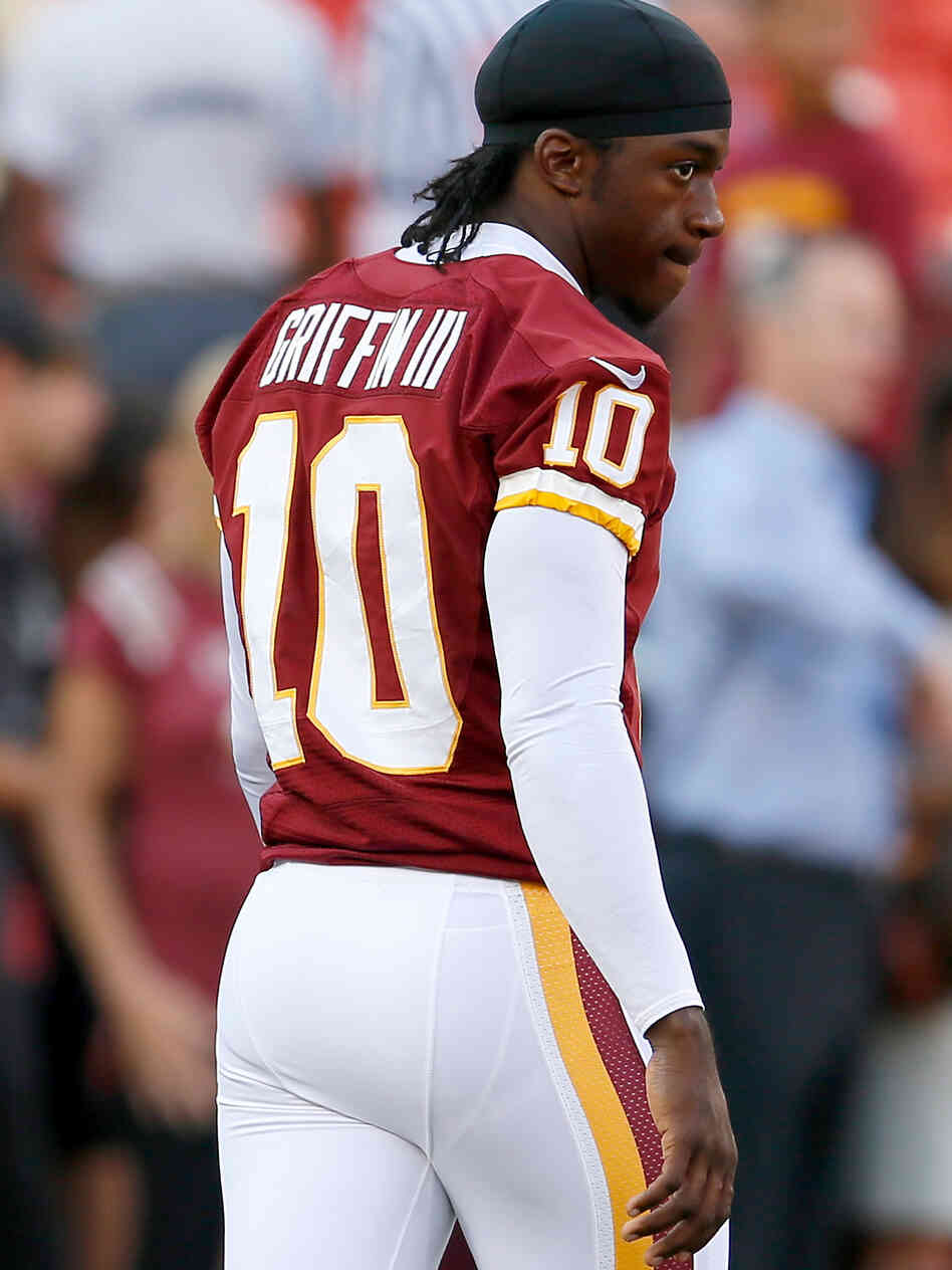 Washington Redskins quarterback Robert Griffin III watches from the sidelines. RG3 as he is known has a fan in other thirds like Frank Deford.