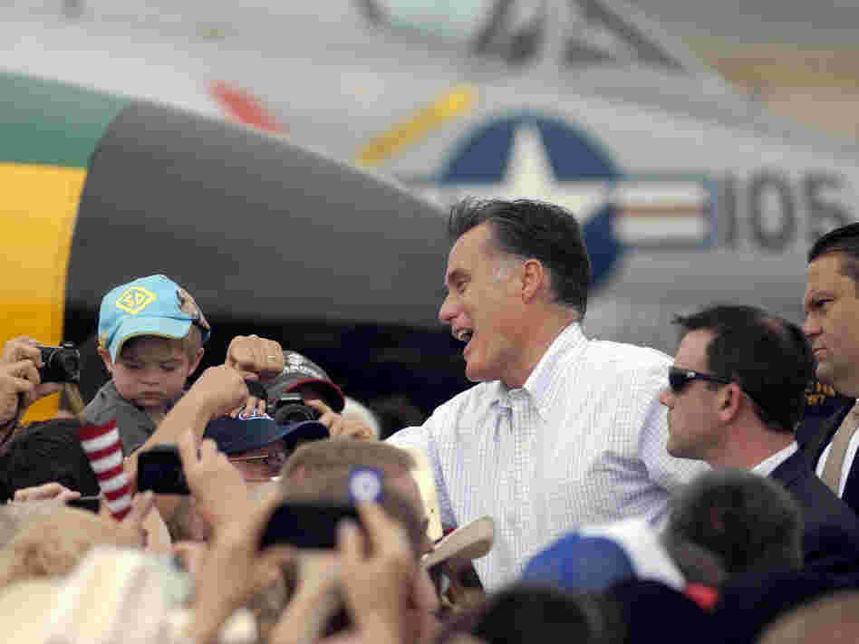 Republican presidential nominee Mitt Romney shakes hands at an aircraft museum in Pueblo, Colo., Monday.
