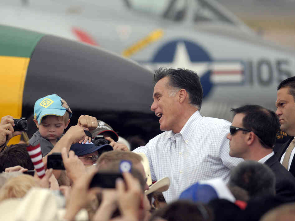 Republican presidential nominee Mitt Romney shakes hands at an aircraft museum in Pueblo, Colo., Monday.