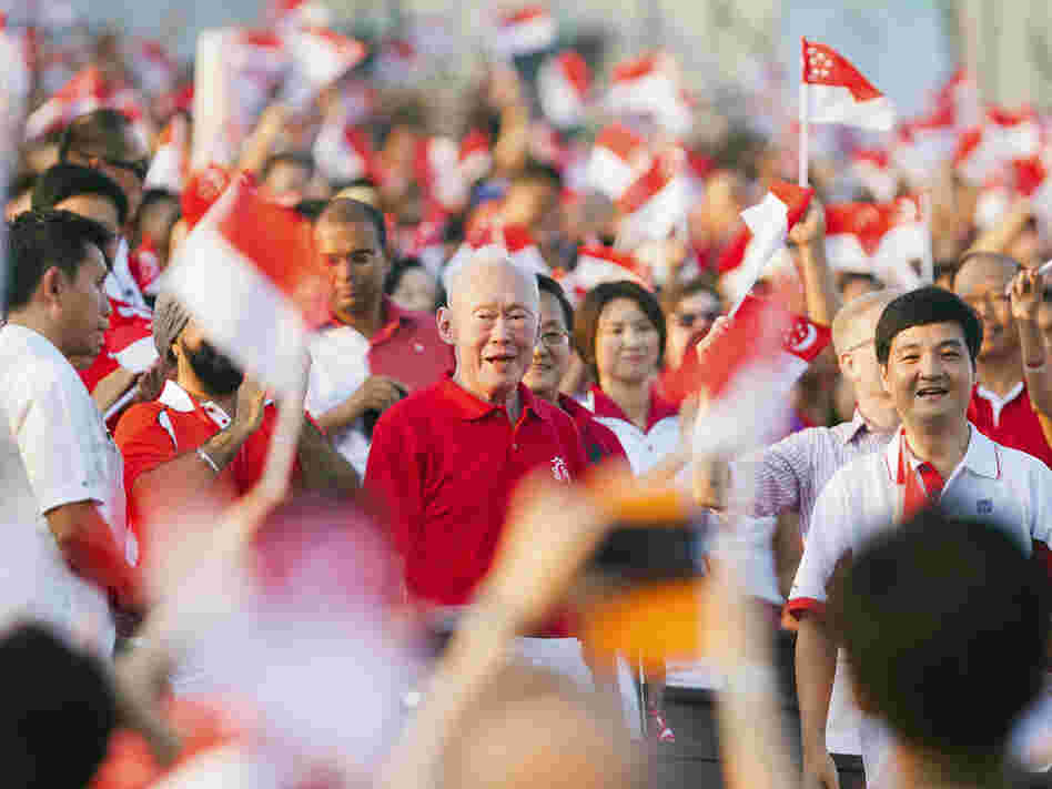 The crowd cheers as Singapore's former Prime Minister Lee Kuan Yew (C) arrives for the annual National Day Parade celebrations in Singapore, Aug. 9. Critics of what they say are the city-state's repressive laws say Lee, Singapore's founding father, used laws such as the Internal Security Act to quash dissent.