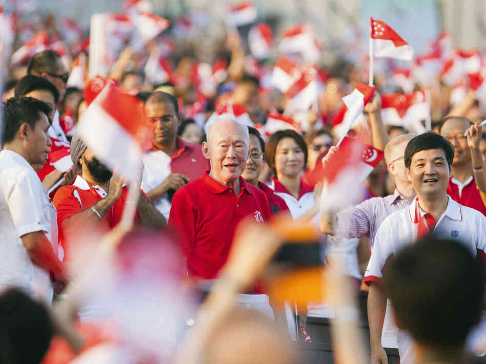 The crowd cheers as Singapore's former Prime Minister Lee Kuan Yew (C) arrives for the annual National Day Parade celebrations in Singapore, Aug. 9. Critics of what they say are the city-state's repressive laws say Lee, Singapore's founding father, used laws such as the Internal Security Act to quash dissent.