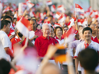 The crowd cheers as Singapore's former Prime Minister Lee Kuan Yew (C) arrives for the annual National Day Parade celebrations in Singapore, Aug. 9. Critics of what they say are the city-state's repressive laws say Lee, Singapore's founding father, used laws such as the Internal Security Act to quash dissent.