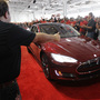 Tesla workers cheer on one of the first Tesla Model S cars sold, during a rally at the Tesla factory in Fremont, Calif., in June. The company is now unveiling a new network of refueling stations for the vehicles. Tesla workers cheer on one of the first Tesla Model S cars sold, during a rally at the Tesla factory in Fremont, Calif., in June. The company is now unveiling a new network of refueling stations for the vehicles.
