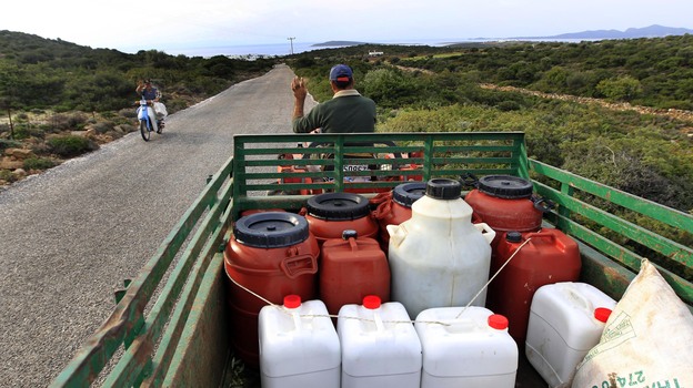 A Greek farmer drives home with his fresh pressed olive oil in barrels near Alyki, Greece. The country's pure olive oil is hard to find, expensive and poorly marketed, businessmen say.
