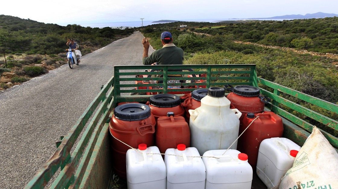 A Greek farmer drives home with his fresh pressed olive oil in barrels near Alyki, Greece. The country's pure olive oil is hard to find, expensive and poorly marketed, businessmen say.