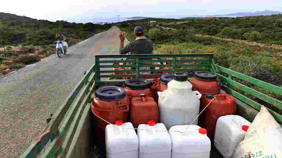 A Greek farmer drives home with his fresh pressed olive oil in barrels near Alyki, Greece. The country's pure olive oil is hard to find, expensive and poorly marketed, businessmen say.