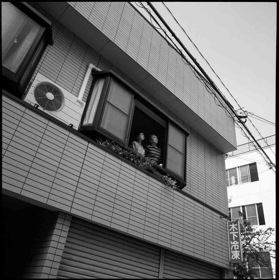 Taniguchi is seen with her sister at their family home, which was rebuilt in the same location where it had stood in 1945. Taniguchi had never heard her sister talk about her experience during the bombing until they were interviewed by photographer Peter Blakely in 2005.