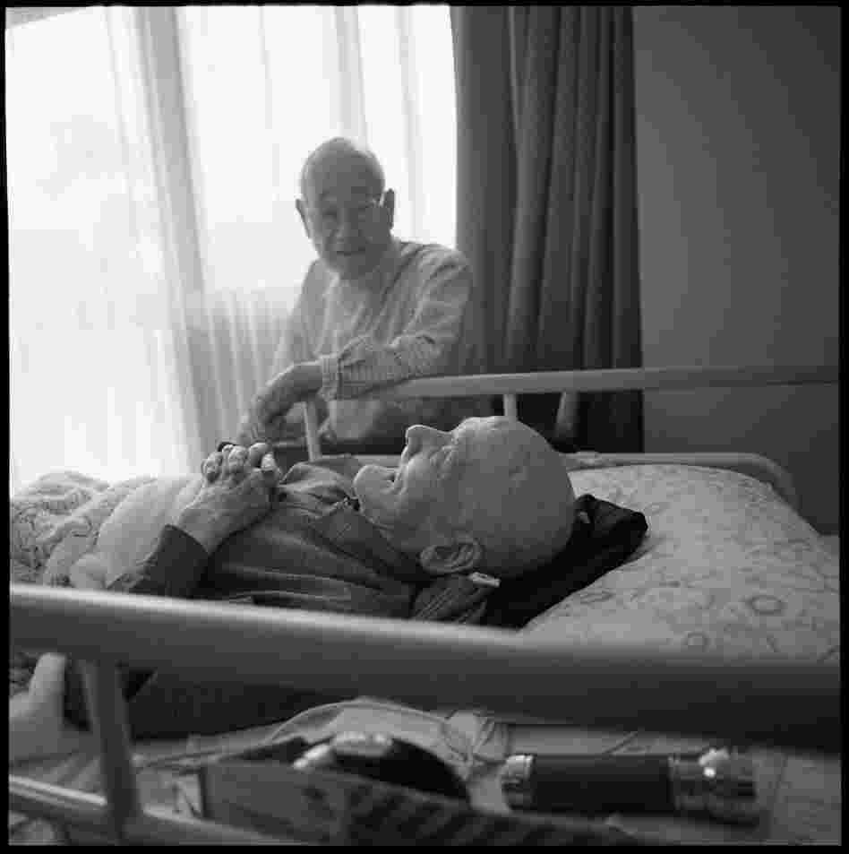 Miyata sits with his roommate. "The closer I got to the hypocenter the more destruction I saw. The city was leveled. I saw bodies as if they were sleeping everywhere. People were lying on the bridge, futons scattered, children with their brains exposed. I felt guilty, I was not hurt. I hope people will remember the horrors of Nagasaki and Hiroshima. ... I pray every day for peace."
