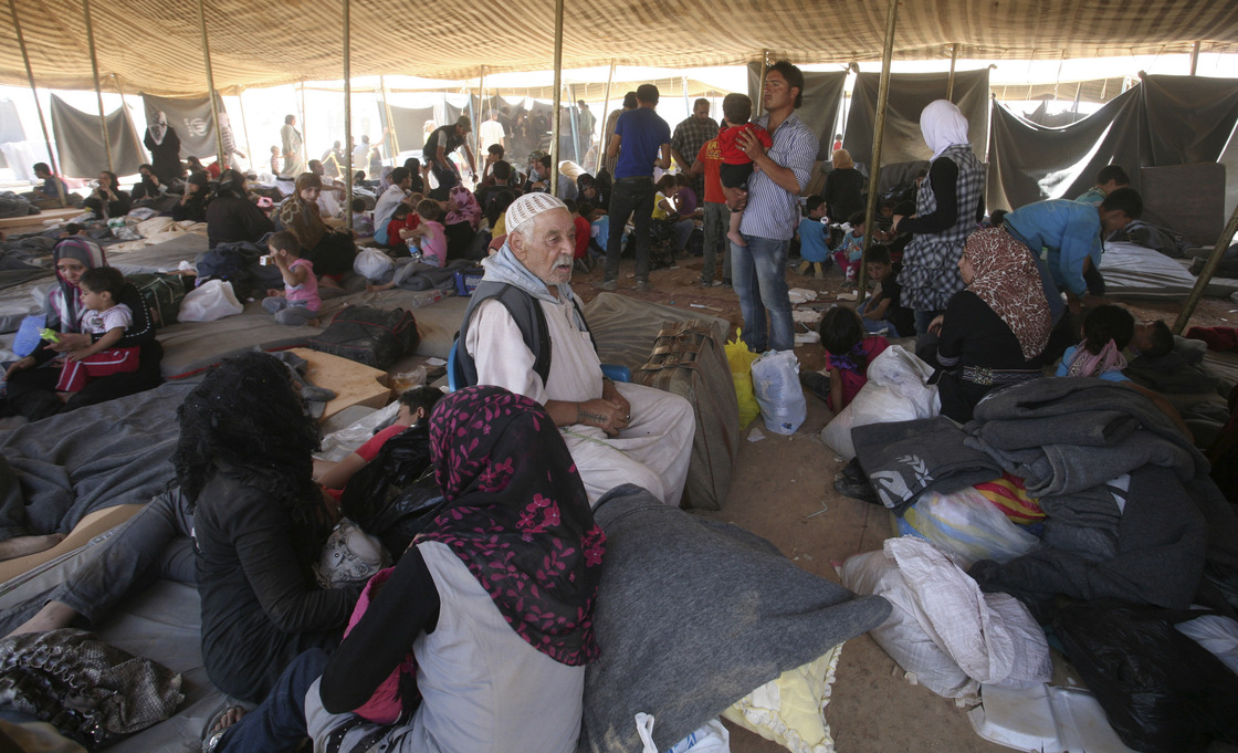 Newly arrived Syrian refugees gather at Zaatari camp, in Mafraq, Jordan, Aug. 29. Residents have rioted over the poor living conditions at the camp. The Jordanian government is not allowing Syrians to leave the camp and join friends or family elsewhere in the country.