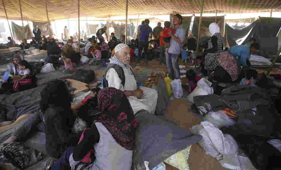 Newly arrived Syrian refugees gather at Zaatari camp, in Mafraq, Jordan, Aug. 29. Residents have rioted over the poor living conditions at the camp. The Jordanian government is not allowing Syrians to leave the camp and join friends or family elsewhere in the country.