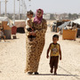 A Syrian refugee walks with her children at Zaatari refugee camp in Mafraq, Jordan, near the Syrian border, Sept. 8. Around 30,000 Syrians live at the camp, with the numbers growing each day.