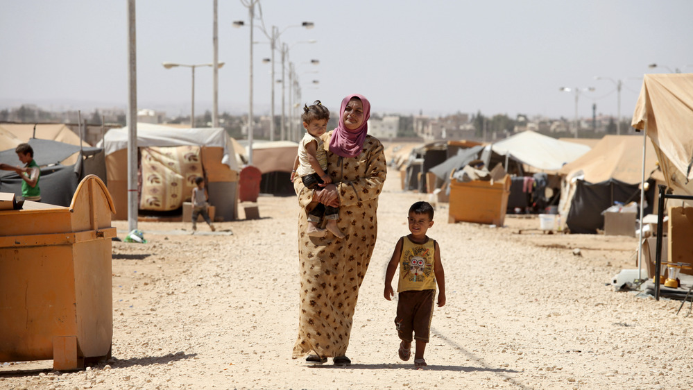 A Syrian refugee walks with her children at Zaatari refugee camp in Mafraq, Jordan, near the Syrian border, Sept. 8. Around 30,000 Syrians live at the camp, with the numbers growing each day.