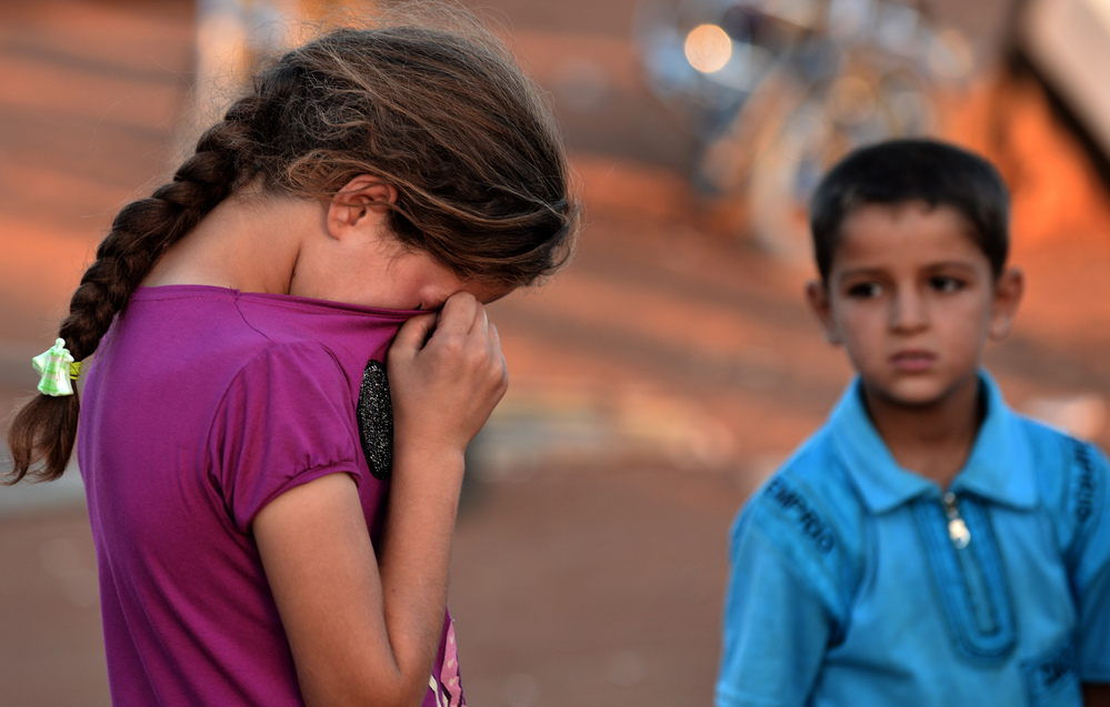 A young Syrian girl wiped her tears after not being allowed entry to Turkey last month. Thousands of Syrians have fled to neighboring countries to escape the civil war raging in their nation.