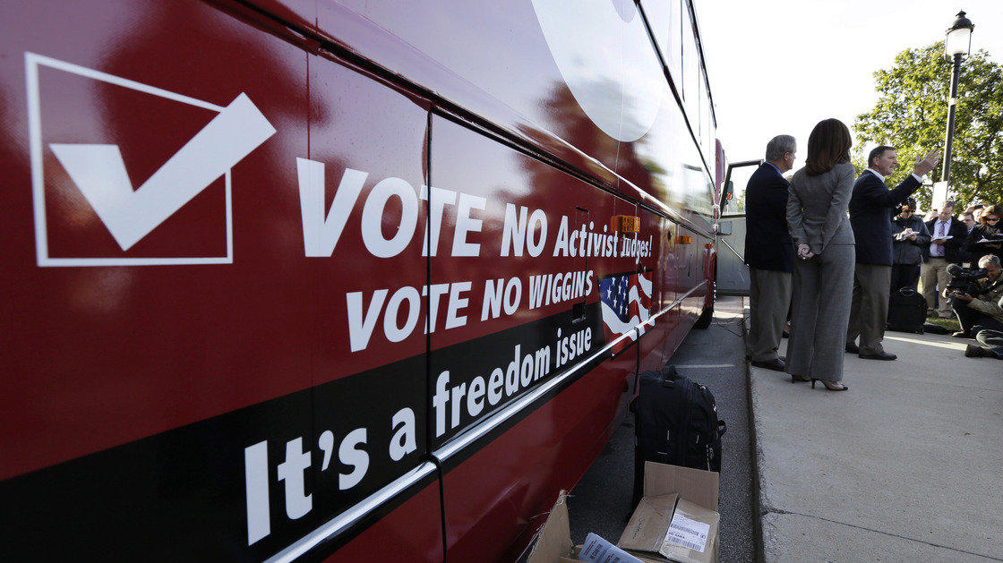 Bob Vander Plaats, president of The Family Leader (right) speaks before a bus tour to urge Iowans to vote state Supreme Court Justice David Wiggins off the bench, in Des Moines, Iowa, on Monday.