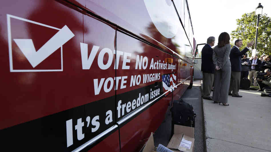 Bob Vander Plaats, president of The Family Leader (right) speaks before a bus tour to urge Iowans to vote state Supreme Court Justice David Wiggins off the bench, in Des Moines, Iowa, on Monday.