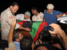 Friends and relatives of Omran Ben Shabaan carried his coffin Tuesday after it arrived as the airport in Misrata, Libya. Friends and relatives of Omran Ben Shabaan carried his coffin Tuesday after it arrived as the airport in Misrata, Libya.