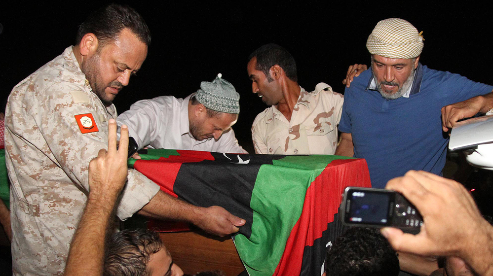 Friends and relatives of Omran Ben Shabaan carried his coffin Tuesday after it arrived as the airport in Misrata, Libya.