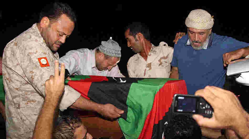 Friends and relatives of Omran Ben Shabaan carried his coffin Tuesday after it arrived as the airport in Misrata, Libya.