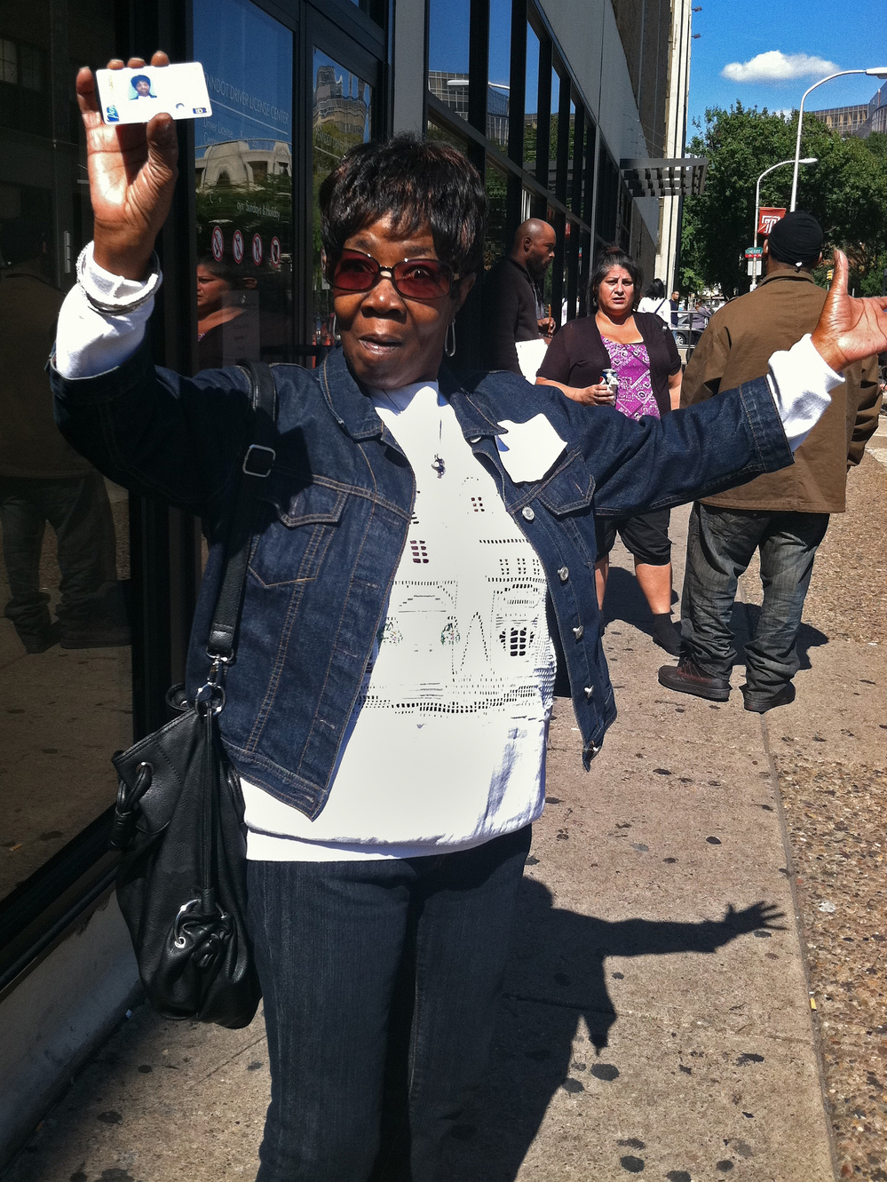 Beverly Mitchell shows off her new photo ID card outside a Philadelphia DMV office. She decided to get the card in case a Pennsylvania court rules to allow the enactment of a state law that requires voters to show photo ID in order to vote.