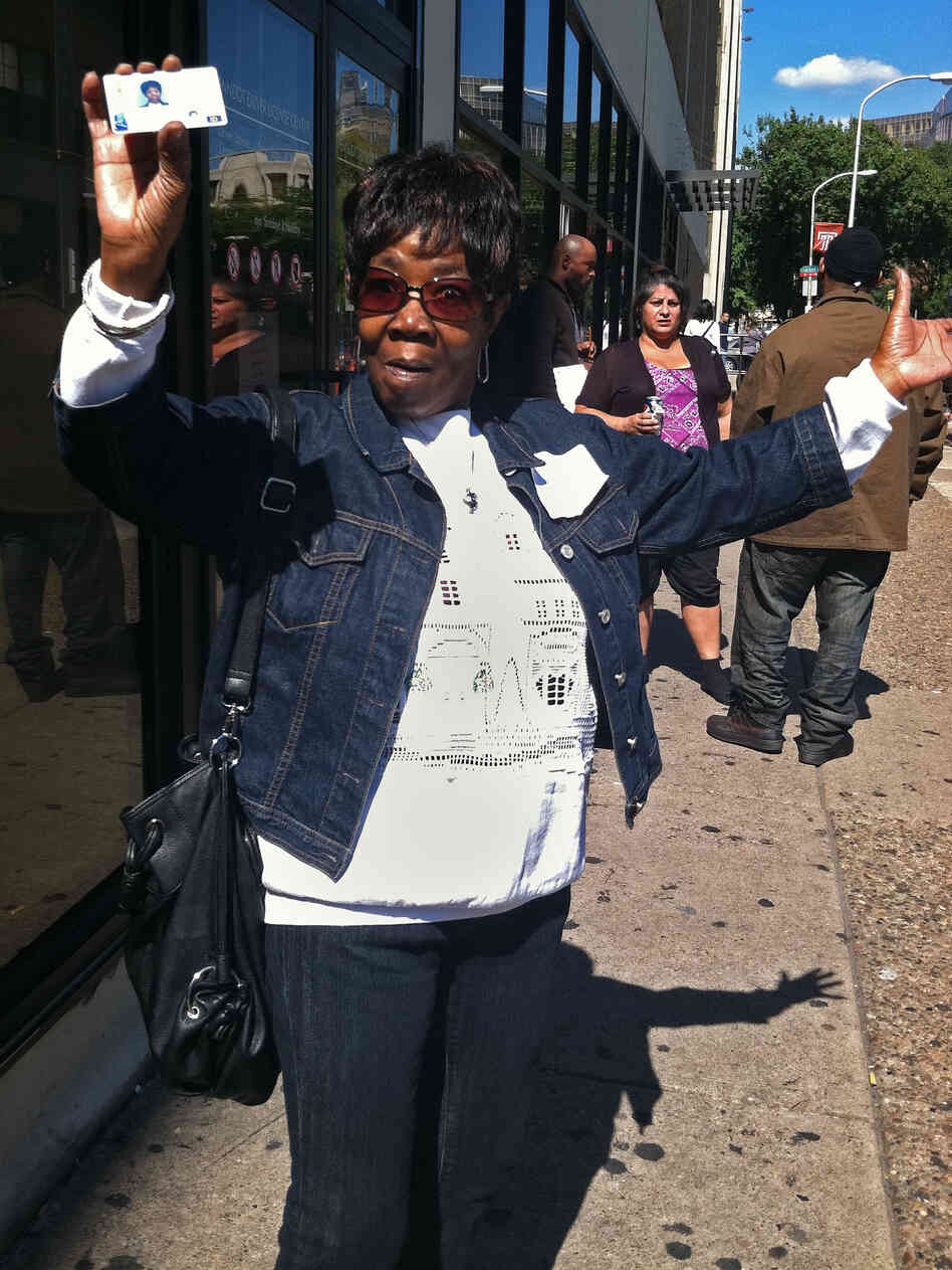 Beverly Mitchell shows off her new photo ID card outside a Philadelphia DMV office. She decided to get the card in case a Pennsylvania court rules to allow the enactment of a state law that requires voters to show photo ID in order to vote.