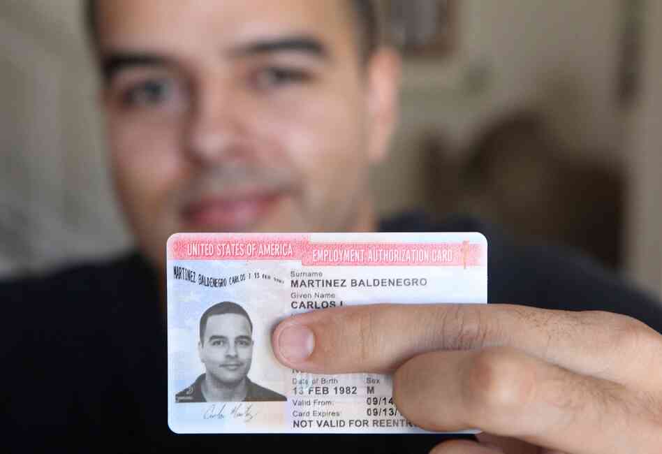 Carlos Martinez, 30, shows off his new work permit, which he received after applying for the Deferred Action for Childhood Arrivals program. Carlos Martinez, 30, shows off his new work permit, which he received after applying for the Deferred Action for Childhood Arrivals program.