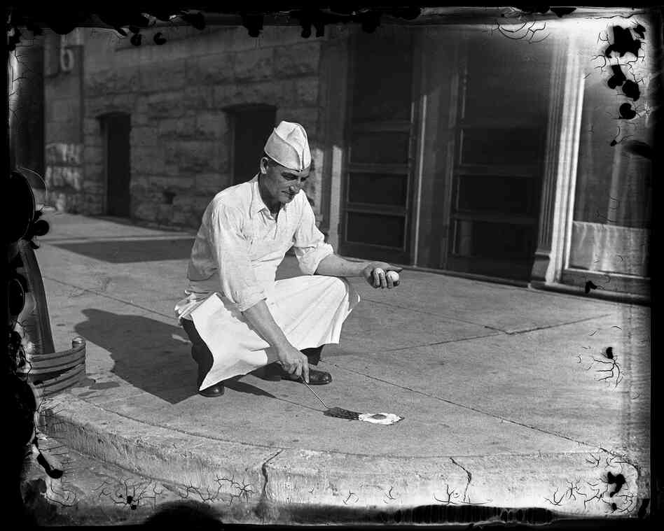 T.M. Travis, owner of Travis Cafeteria at 624 E. Capitol Ave., tries to prove, or disprove, the belief that it is sometimes hot enough to fry an egg on the sidewalk in July 1930. Despite it being 115 degrees on the concrete, the experiment did not work.