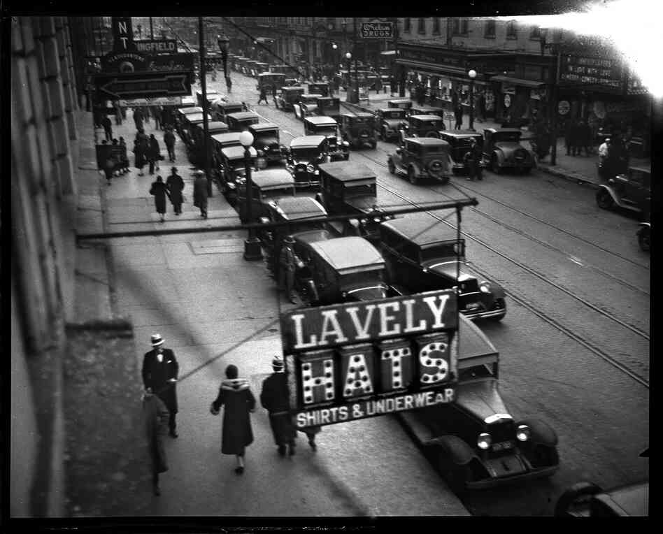 In 1930, the Illinois Power Co. operated the city's buses and streetcars and advertised regularly in the Journal, promoting the advantages of using mass transportation. The photo staff was assigned to capture street scenes that showed congestion, and their photographs were used in the ads. This image shows Monroe Street facing west from Sixth Street, December 16, 1930.