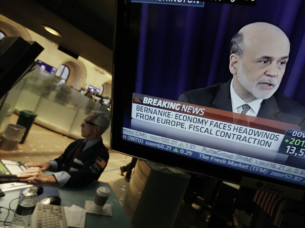 Specialist David Pologruto works at his post on the floor of the New York Stock Exchange on Sept. 13, as Federal Reserve Chairman Ben Bernanke holds a news conference in Washington. The world's central banks are easing credit, putting more money into the global economy.