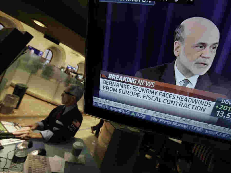 Specialist David Pologruto works at his post on the floor of the New York Stock Exchange on Sept. 13, as Federal Reserve Chairman Ben Bernanke holds a news conference in Washington. The world's central banks are easing credit, putting more money into the global economy.