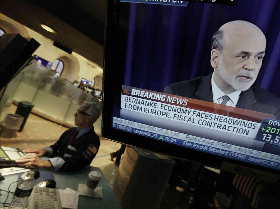 Specialist David Pologruto works at his post on the floor of the New York Stock Exchange on Sept. 13, as Federal Reserve Chairman Ben Bernanke holds a news conference in Washington. The world's central banks are easing credit, putting more money into the global economy.