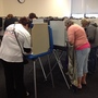 Iowans vote Thursday at the Polk County Auditor's Office in Des Moines. Voters lined up before the doors opened at 8 a.m. to cast ballots. At least 200 people had arrived within the first hour.