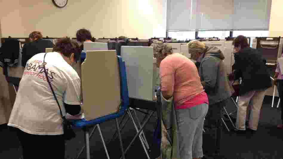 Iowans vote Thursday at the Polk County Auditor's Office in Des Moines. Voters lined up before the doors opened at 8 a.m. to cast ballots. At least 200 people had arrived within the first hour.