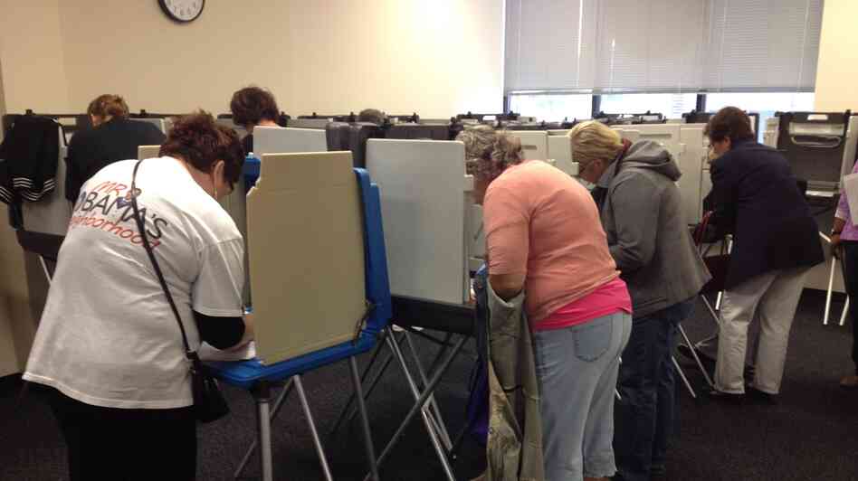 Iowans vote Thursday at the Polk County Auditor's Office in Des Moines. Voters lined up before the doors opened at 8 a.m. to cast ballots. At least 200 people had arrived within the first hour.