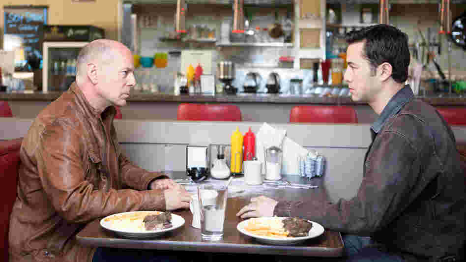 Old Joe (Bruce Willis) and his younger self (Joseph Gordon-Levitt), two iterations of the same assassin, play a particularly personal game of cat and mouse in the time-travel thriller Looper. Old Joe (Bruce Willis) and his younger self (Joseph Gordon-Levitt), two iterations of the same assassin, play a particularly personal game of cat and mouse in the time-travel thriller Looper.