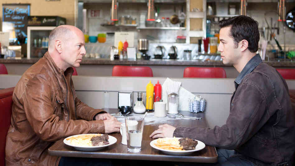 Old Joe (Bruce Willis) and his younger self (Joseph Gordon-Levitt), two iterations of the same assassin, play a particularly personal game of cat and mouse in the time-travel thriller Looper. Old Joe (Bruce Willis) and his younger self (Joseph Gordon-Levitt), two iterations of the same assassin, play a particularly personal game of cat and mouse in the time-travel thriller Looper.