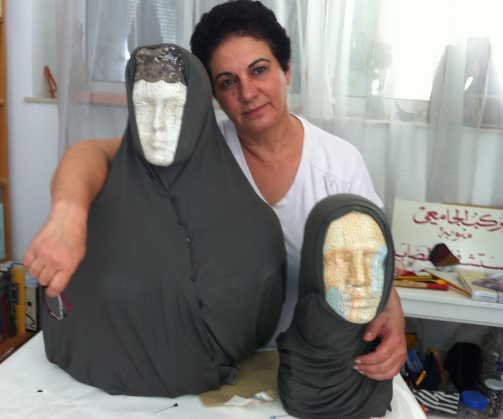 Tunisian artist Nadia Jelassi with two of the sculptures from her exhibit that were attacked by a hard-line Muslim group. Secular Tunisians and Islamists have clashed over multiple issues related to freedom of expression.