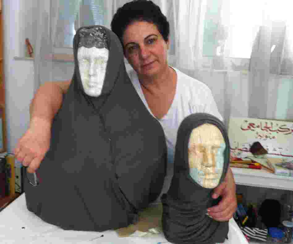 Tunisian artist Nadia Jelassi with two of the sculptures from her exhibit that were attacked by a hard-line Muslim group. Secular Tunisians and Islamists have clashed over multiple issues related to freedom of expression.