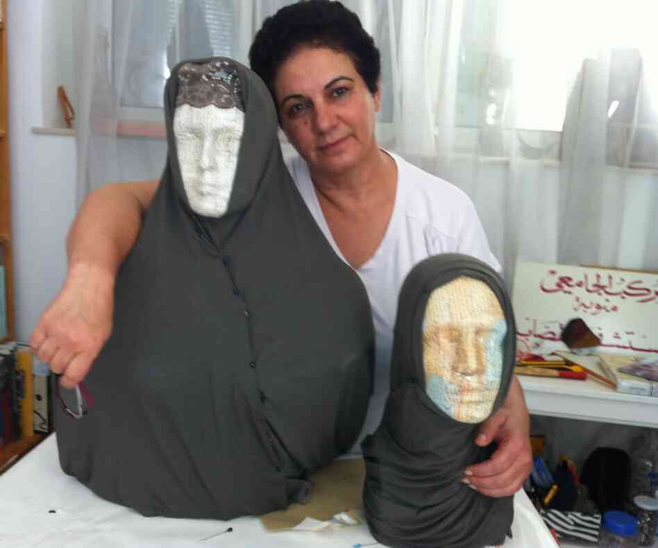 Tunisian artist Nadia Jelassi with two of the sculptures from her exhibit that were attacked by a hard-line Muslim group. Secular Tunisians and Islamists have clashed over multiple issues related to freedom of expression.
