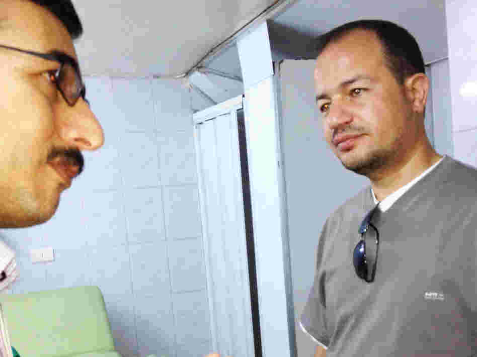 Dr. Zaher Sahloul (right) speaks with local staff at a field hospital in Aldana. Sahloul, a pulmonary specialist from Chicago, attended medical school with Syrian President Bashar Assad and is on his fifth medical mission to Syria.