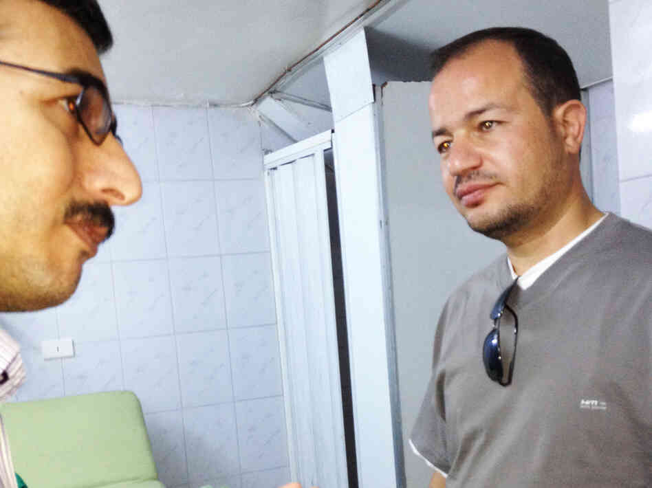 Dr. Zaher Sahloul (right) speaks with local staff at a field hospital in Aldana. Sahloul, a pulmonary specialist from Chicago, attended medical school with Syrian President Bashar Assad and is on his fifth medical mission to Syria.