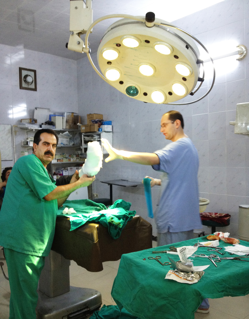 Local Syrian doctors prepare to treat a patient in a field hospital in Aldana, Syria, near the Turkish border. Each day, local and expatriate doctors take big risks to treat the wounded in rebel-held areas.