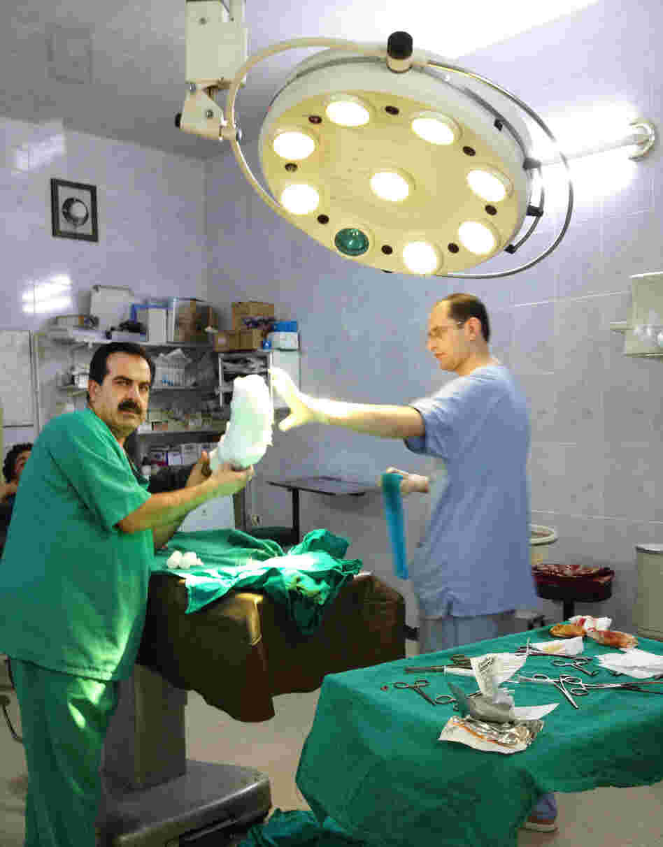 Local Syrian doctors prepare to treat a patient in a field hospital in Aldana, Syria, near the Turkish border. Each day, local and expatriate doctors take big risks to treat the wounded in rebel-held areas.