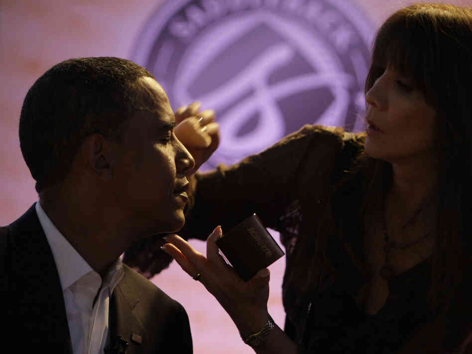 Then-Sen. Barack Obama gets makeup applied at a presidential candidate forum in Lake Forest, Calif., on Aug. 16, 2008.
