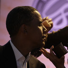 Then-Sen. Barack Obama gets makeup applied at a presidential candidate forum in Lake Forest, Calif., on Aug. 16, 2008.