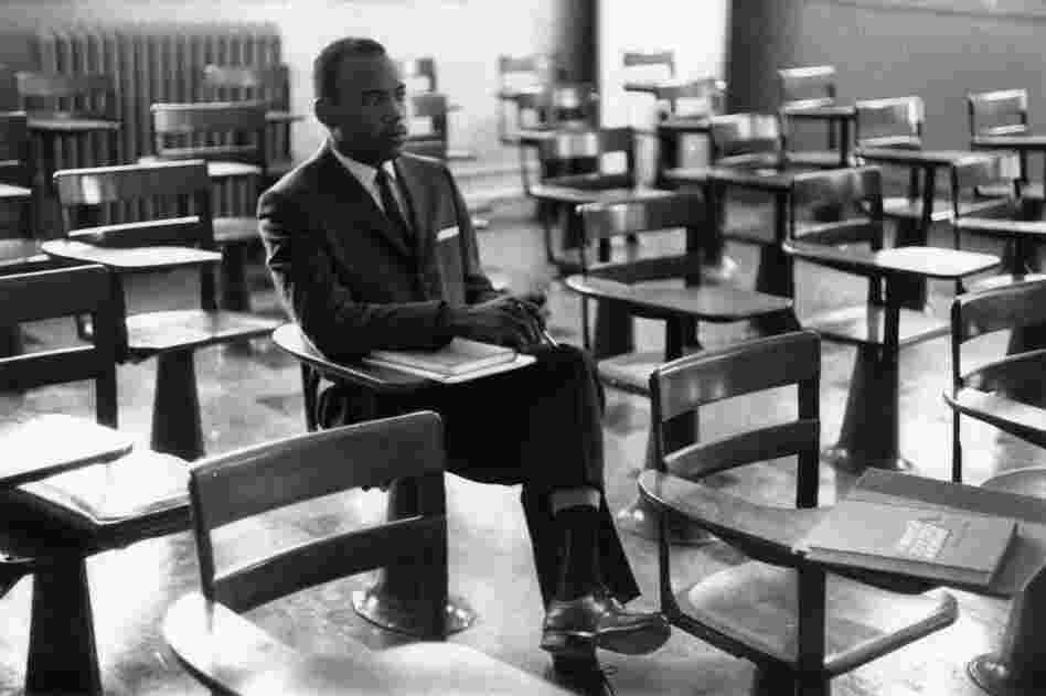 Meredith sits alone on his first day of class. A photographer who was there remembers the other students leaving the room in protest.
