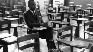 Meredith sits alone on his first day of class. A photographer who was there remembers the other students leaving the room in protest.