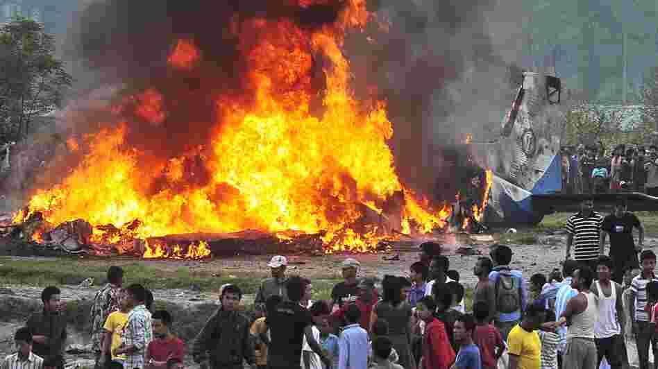 Plane wreckage burns near the airport in Katmandu, Nepal, following an accident that killed 19 people aboard.