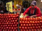 A worker separates tomatoes at a market in Mexico City. The Commerce Department says it might act to end a 16-year-old trade deal governing fresh Mexican tomatoes sold in the U.S. A worker separates tomatoes at a market in Mexico City. The Commerce Department says it might act to end a 16-year-old trade deal governing fresh Mexican tomatoes sold in the U.S.